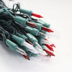 100-bulb Candy Cane (Red Clear Frost) Mini Lights, 4" Spacing, Green Wire 11 100-bulb Candy Cane (Red Clear Frost) Mini Lights, 4" Spacing, Green Wire -Christmas Light Store red clear white frost glass mini lights green wire a